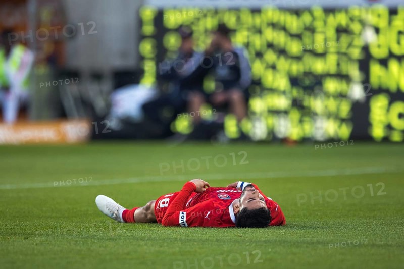 Football match, Kevin SESSA 1. FC Heidenheim lying exhausted on the ground with his head up and his legs slightly apart, football stadium Voith-Arena, Heidenheim