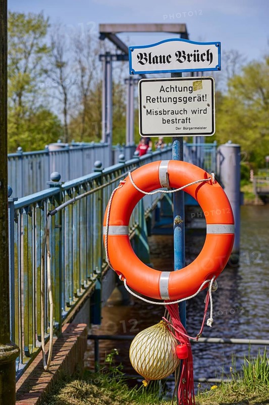 Lifebuoy with sign Abuse will be punished and information board Blaue Brueck in Friedrichstadt, Nordfriesland district, Schleswig-Holstein, Germany, Europe