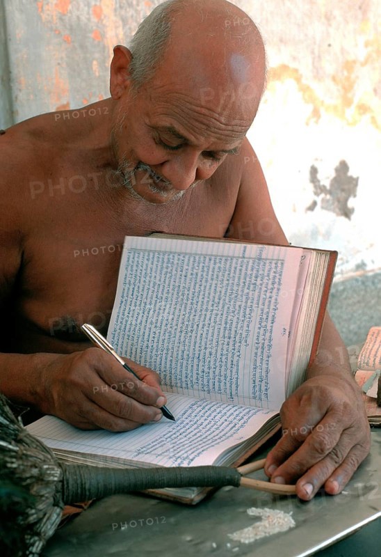 Jain monk writing his thoughts on his personal book, naked monk from the digambar sect, Rajasthan, India, Asia