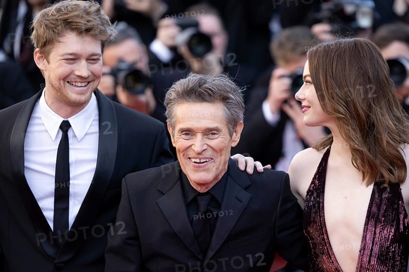 Cannes, France, 17.5.2024: Joe Alwynbei, Willem Dafoe and Emma Stone at the premiere of Kinds of Kindness on the red carpet of the Palais des Festivals during the 77th Cannes International Film Festival. The 77th Cannes International Film Festival will take place from 14 to 25 May 2024, Europe