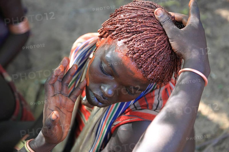 South Ethiopia, Omo region, among the Hamar tribe, Hamer, Hamma, Hammer, Amar or Amer, woman adorn themselves with face paint and dye their hair with ochre-coloured clay and grease for the initiation ritual, the bull jump, Ethiopia, Africa