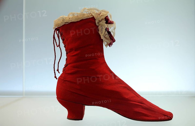 Red silk boot from around 1870 Fashion Department at the Victoria & Albert Museum, 1-5 Exhibition Rd, London, England, Great Britain
