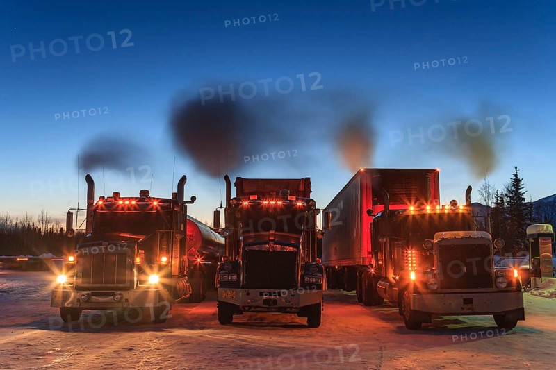 Three American trucks with engine running, truck, twilight, winter, Coldfoot, Alaska, USA, North America
