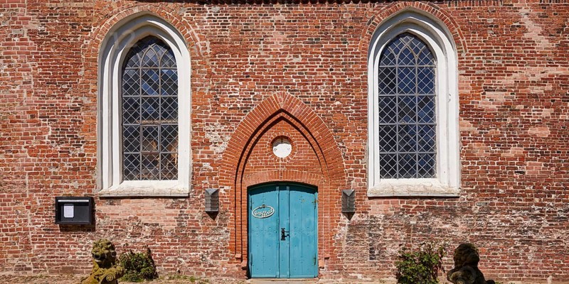 Window and entrance door to St Laurentius Church in Toenning, North Friesland district, Schleswig-Holstein, Germany, Europe