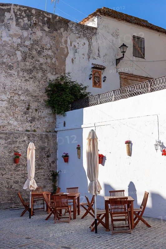 Tables and chairs of a small cafe in the white town of Vejer in the mountains, Andalusia, Spain, Europe