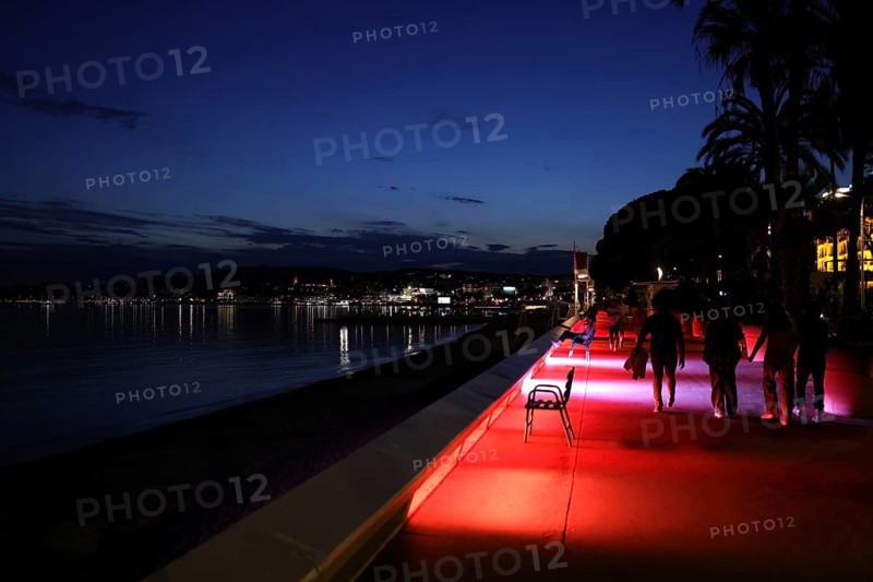 Cannes, France, 13 May 2024: People stroll along the Boulevard de la Croisette on the eve of the opening of the festival. The 77th Cannes International Film Festival will take place from 14 to 25 May 2024, Europe