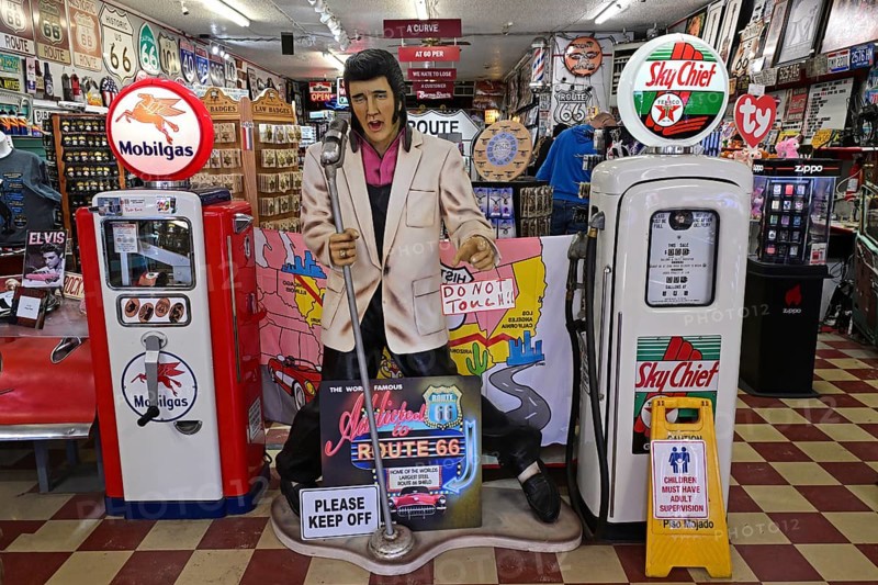 Elvis between historic petrol pumps in a souvenir shop, Williams, Arizona