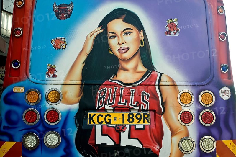 Decorated public transport called Matatu, young woman fan of the basket ball team Chicago Bulls, Nairobi, Kenya, Africa