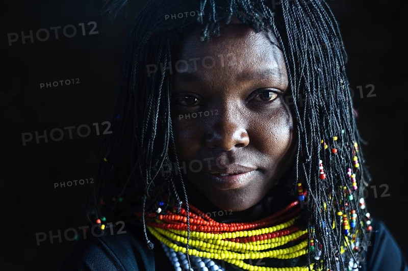 Portrait of a young woman from the Turkana tribe Kenya . After leaving the region inhabited by the Turkana tribe, her family (as well as other families) is on the process of acculturation