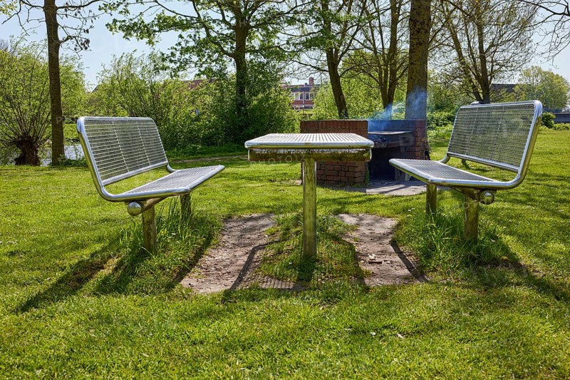 Public barbecue area with brick-built, smoking barbecue and stainless steel tables and benches in Friedrichstadt, Nordfriesland district, Schleswig-Holstein, Germany, Europe