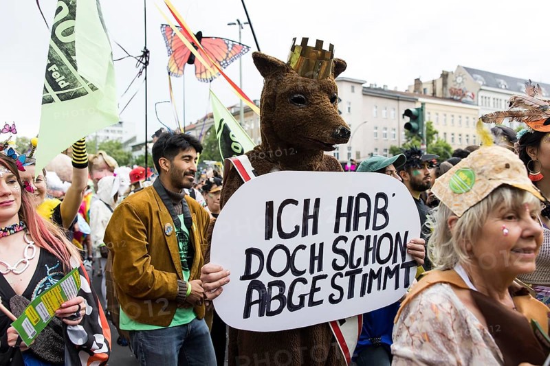 Dancer of the group 100% Tempelhofer Feld dressed as a Berlin bear with a sign Ich hab doch schon abgestimmt at the street parade of the 26th Carnival of Cultures in Berlin on 19 May 2024