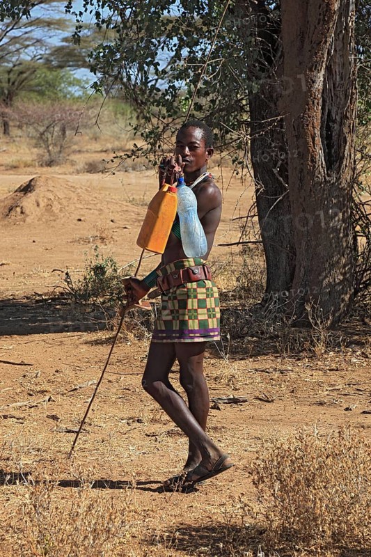 South Ethiopia, Omo region, man from the Karo people with water bottles, plastic bottles filled with water, Ethiopia, Africa