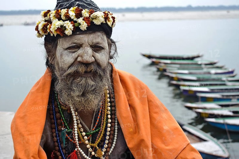 Portrait of a hindu ascetic, sadhu belonging to the naga order, Ganges river in the background, Varanasi, India, Asia