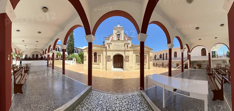 Panoramic photo view through archway to main entrance portal of orthodox church monastery church Zoodochos Pege in Byzantine style from 14th century in today's nunnery monastery of Panagia Kalyviani Kaliviani, Faneromeni, Tymbaki, Crete, Greece, Europe