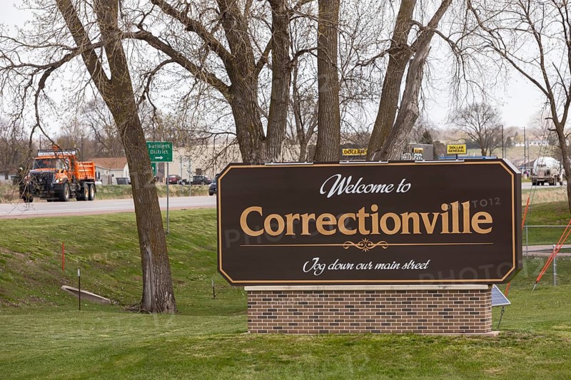 Correctionville, Iowa, A sign welcomes travelers to Correctionville. The town was named because of the surveyors' 1855 correction line that runs through the village. Surveyors need correction lines because of the curvature of the earth