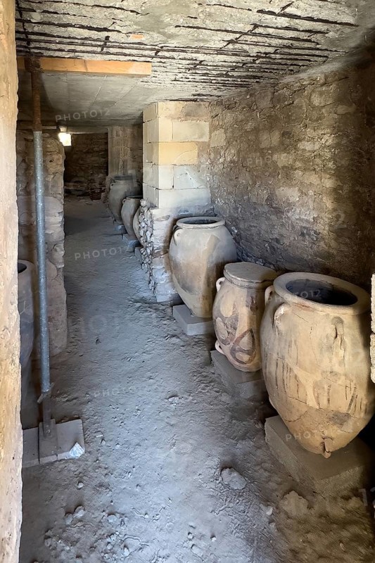 View into above with modern concrete ceiling protected historical storeroom with large decorated clay vessels Pithoi in ancient magazine building with supplies in excavation site on hill of Phaistos palace of Minoan culture pre-Greek ancient Greek people Minoans in antiquity, Kamilari, Crete, Greece, Europe