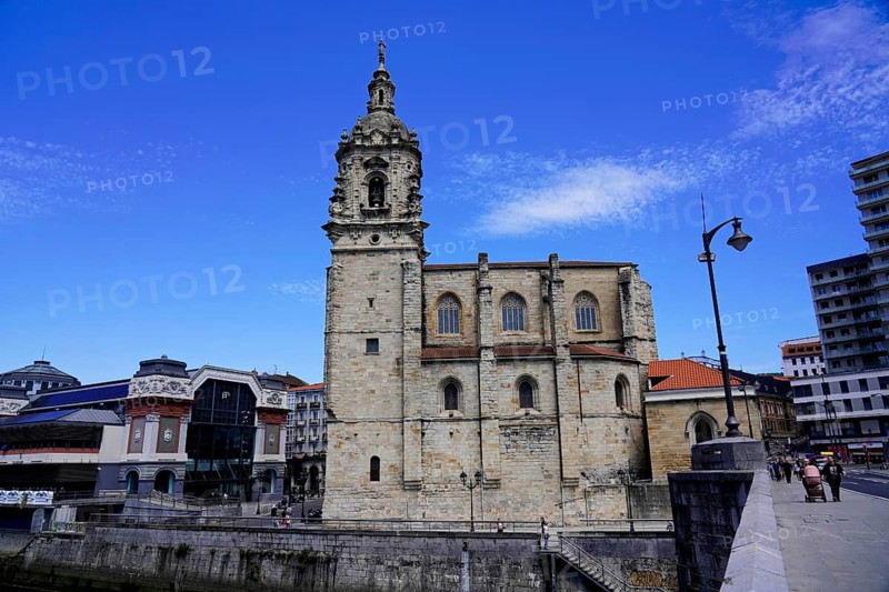 The Iglesia de San Anton church on the Nervion river in Bilbao, church in the city centre with historic stone architecture and modern building in the background, The Iglesia de San Anton church on the Nervion river in Bilbao. Built in 1510, the church is a Catholic place of worship in the historic city centre. It is built in the Gothic style with Baroque elements, BILBAO, Spain, Europe
