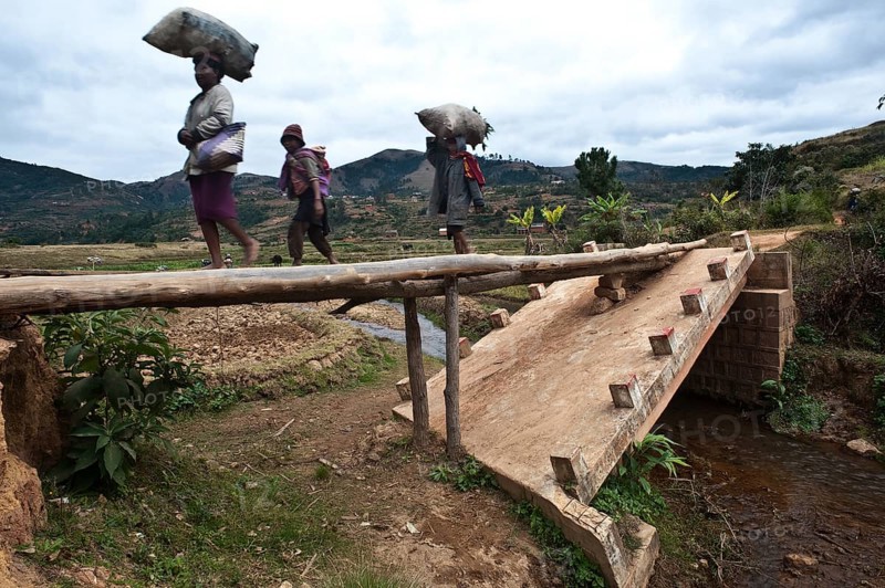 Broken concrete bridge replaced by a bridge made of trunks, Ambositra, Madagascar, Africa