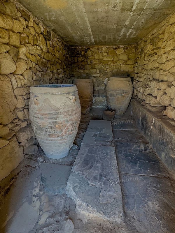 View into historical storeroom below present floor level with three large decorated clay vessels Pithoi in ancient magazine building with supplies in excavation site on hill of Phaistos palace of Minoan culture pre-Greek ancient Greek people Minoans in antiquity, Kamilari, Crete, Greece, Europe