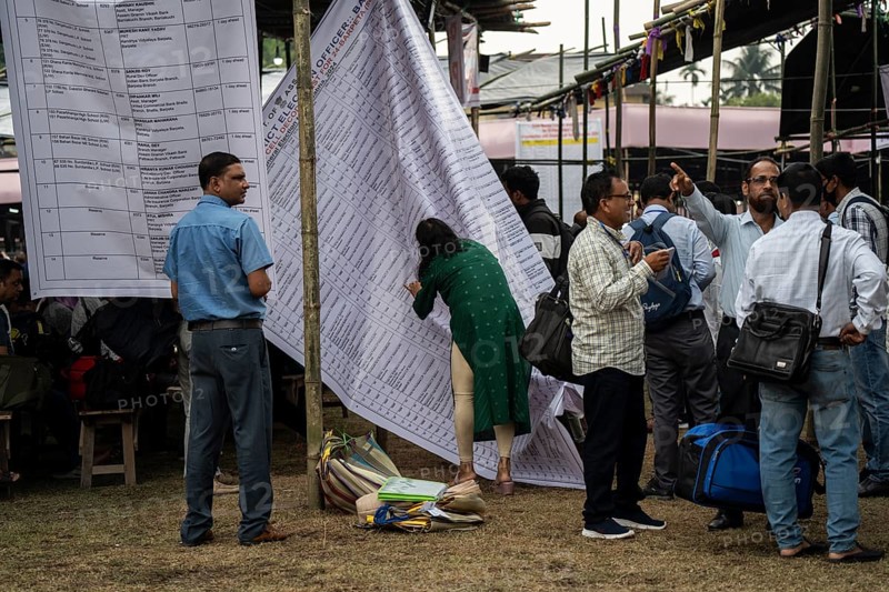 Barpeta, India. 6 May 2024. Polling officials check their name allocated polling station name, on the eve of the third phase of General Election on May 6, 2024 in Barpeta, India, Asia