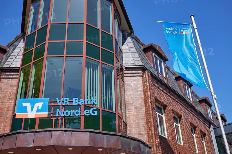 Logo of Volksbank Raiffeisenbank VR Bank Nord eG with flags at the Niebuell branch, Nordfriesland district, Schleswig-Holstein, Germany, Europe