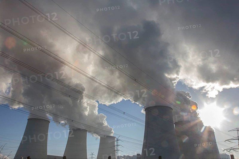 Steam rises from the cooling towers of the Vattenfall power plant in Jaenschwalde, power lines and electricity pylons at the power plant on 9 December 2014. The energy company Vattenfall mines lignite to generate electricity in the surrounding open-cast mines in Brandenburg, Jaenschwalde, Brandenburg, Germany, Europe