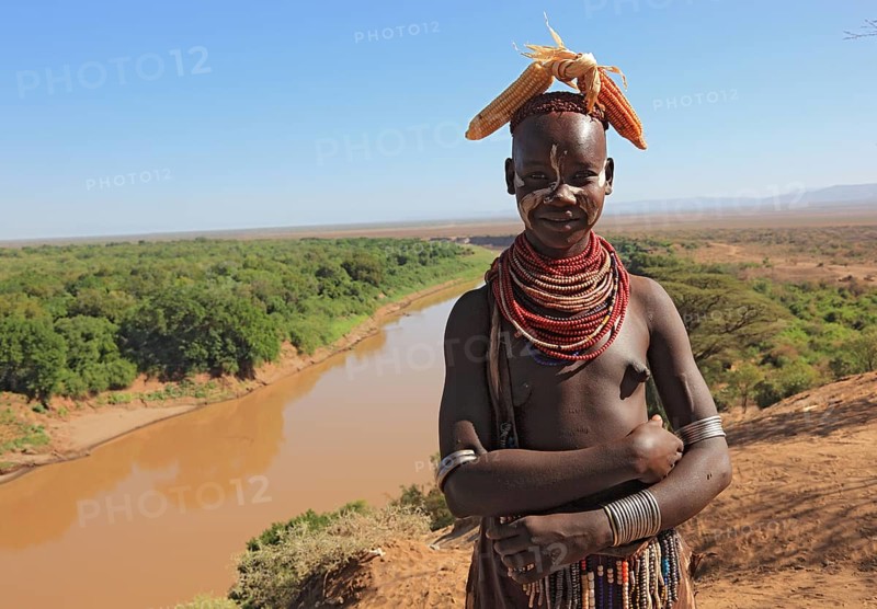 Southern Ethiopia, Omo region, Omo river landscape, proud woman of the Karo people with headdress, necklaces and face painting, Ethiopia, Africa