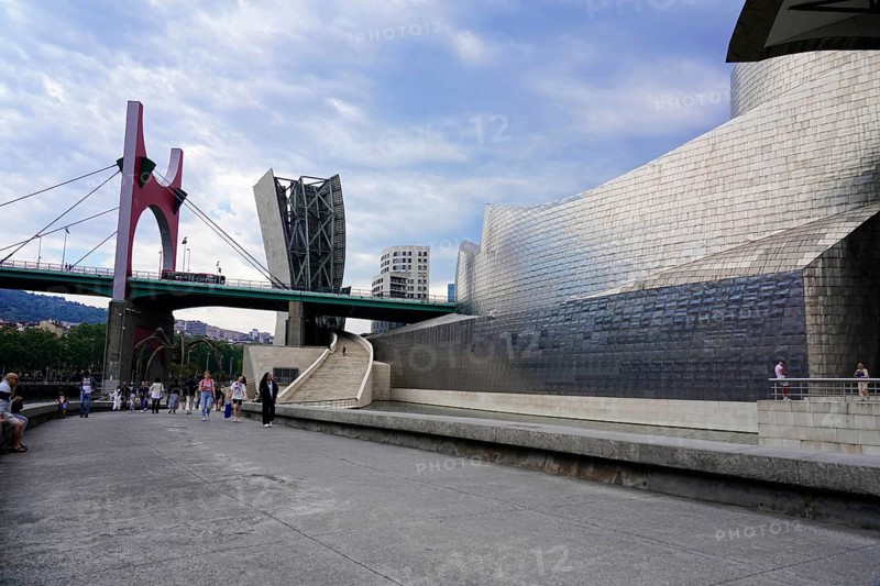 Guggenheim Museum, Bilbao, Basque Country, Spain, Europe, A modern building next to a bridge, surrounded by people, under a cloudy sky, Guggenheim Museum Bilbao on the banks of the river Nervion, architect Frank O. Gehry, Europe