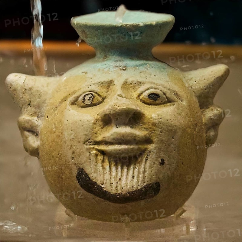 Aryballos, in the shape of the head of Acheloos, a river god, in antique ceramic vessel with funny face and water, moulded in detail, motif cropped, background AI generated, interiors, Archaeological Museum, Old Town, Rhodes Town, Rhodes, Dodecanese, Greek Islands, Greece, Europe