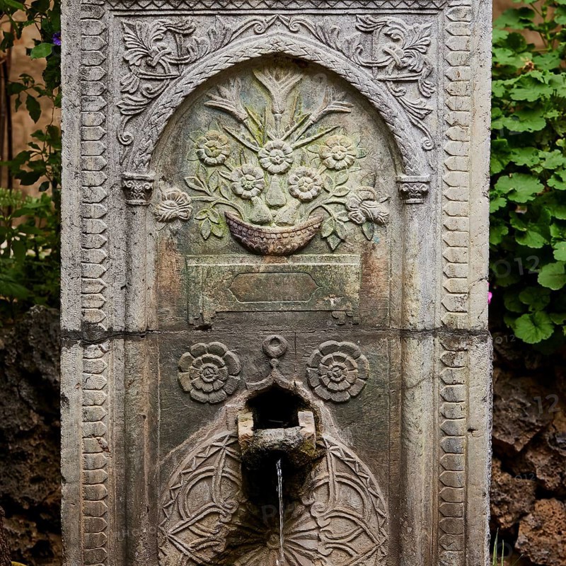 Artfully engraved stone fountain with plant motifs, water flowing out, outdoor area, Archaeological Museum, Old Town, Rhodes Town, Rhodes, Dodecanese, Greek Islands, Greece, Europe