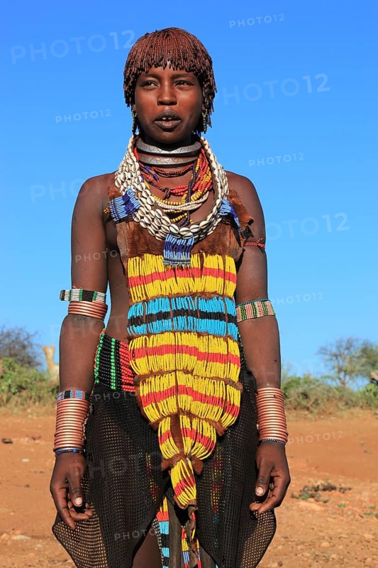 South Ethiopia, Omo region, young woman of the Hammer people, wears a lot of jewellery and her hair is dyed with a mixture of ochre clay and fat, Ethiopia, Africa