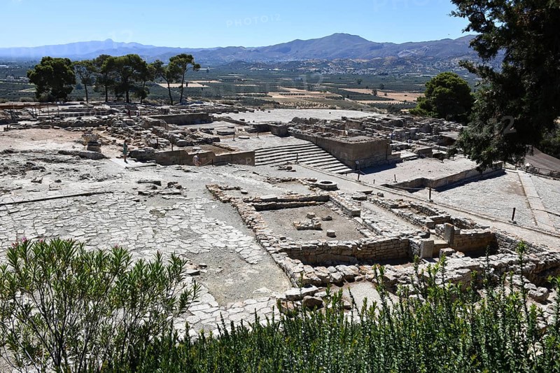 View of the upper part of the settlement of Phaistos with upper square courtyard open space court on the left next to the foundation walls on the right, behind it in the centre of the picture monumental staircase open stairway to and remains of the ground plan of the palace of Phaistos of the Minoan culture of pre-Greek people Minoans in antiquity, Kamilari, Crete, Greece, Europe