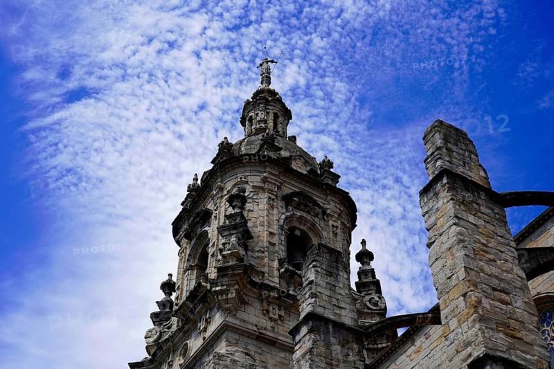 The Iglesia de San Anton church on the Nervion river in Bilbao, detail of the Gothic bell tower of a historic church under a blue sky, The Iglesia de San Anton church on the Nervion river in Bilbao. Built in 1510, the church is a Catholic place of worship in the historic centre. It is built in the Gothic style with Baroque elements, BILBAO, Spain, Europe