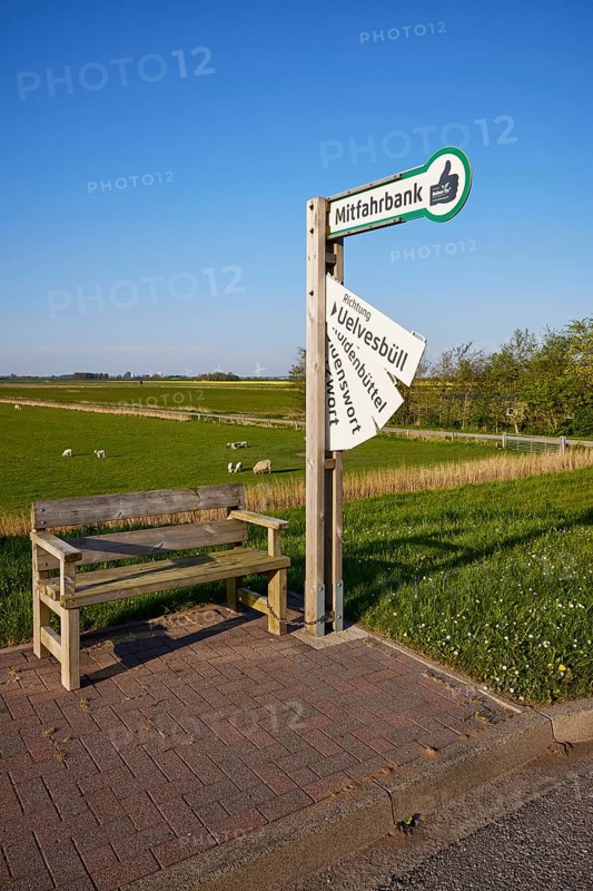 Carpooling bench and sign with fold-out destination boards in the marshland near Simonsberg, Nordfriesland district, Schleswig-Holstein, Germany, Europe