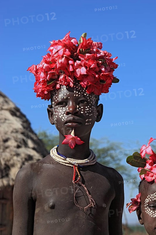 South Ethiopia, Omo region, tribal members of the Karo people, with floral decorations and body painting, Ethiopia, Africa