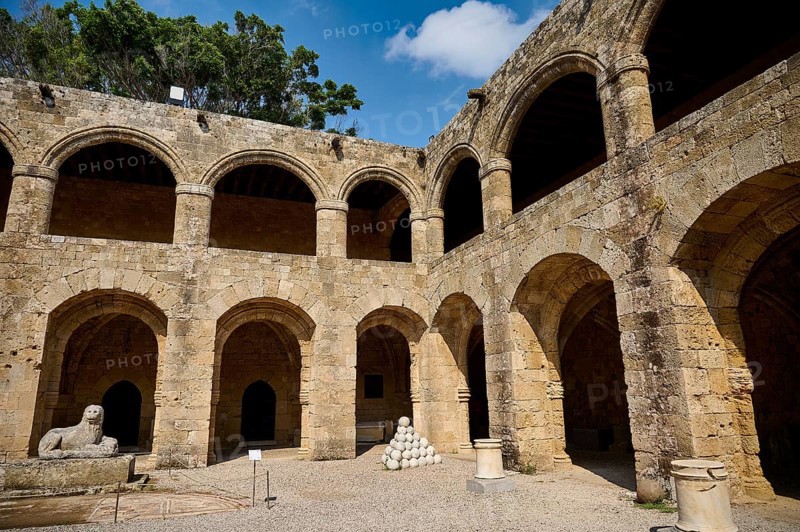 Courtyard of a medieval fortress under a blue sky, surrounded by trees with lion statue, outdoor area, Archaeological Museum, Old Town, Rhodes Town, Rhodes, Dodecanese, Greek Islands, Greece, Europe