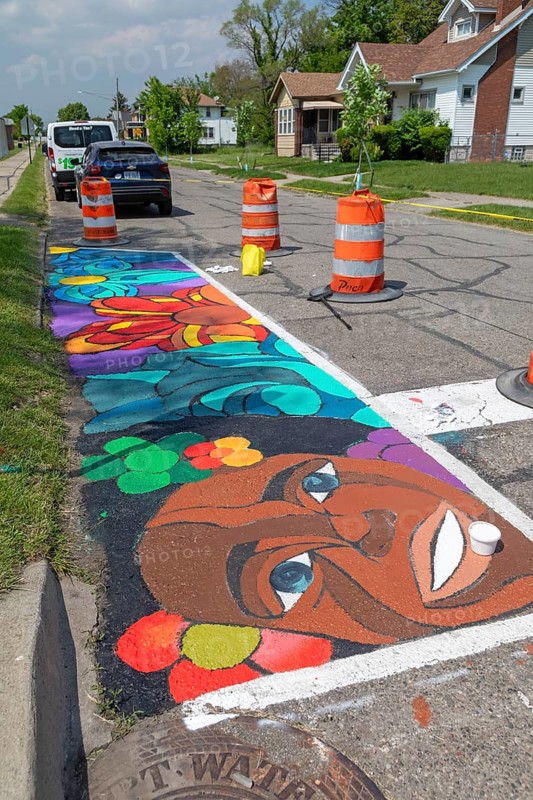 Detroit, Michigan, Artists and students from Noble Elementary-Middle School painted designs on streets near their school. It was part of City Walls, a city program that adds art to Detroit neighborhoods. City Walls has painted more than 200 murals in the city, most of them on walls