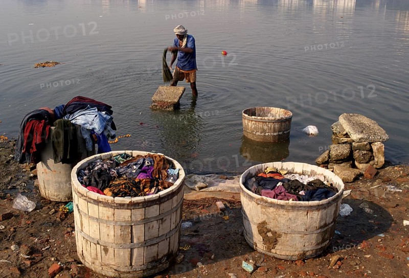 Man washing clothes in the Sabarmati river, Ahmedabad, Gujarat, India, Asia