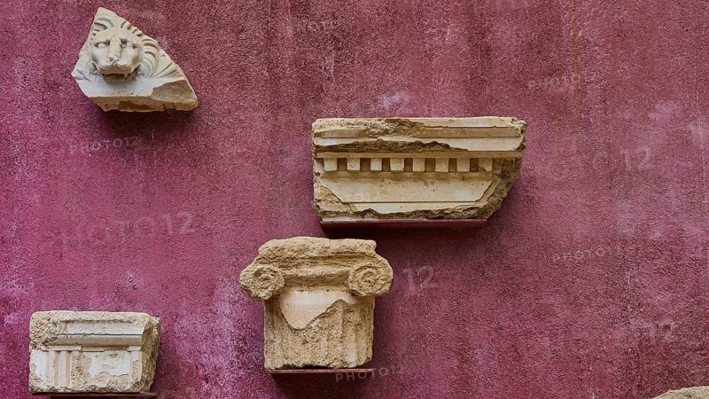 Architectural fragments of stone, ancient marble pieces attached to a wall, outdoor area, Archaeological Museum, Old Town, Rhodes Town, Rhodes, Dodecanese, Greek Islands, Greece, Europe