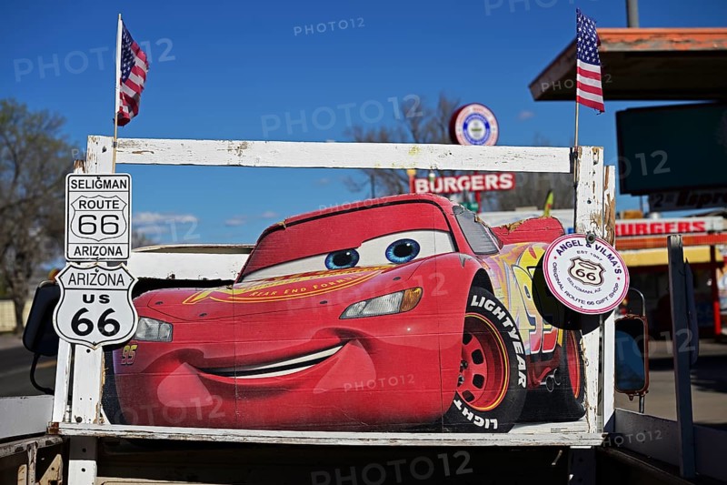 Lightning McQueen, the main protagonist and racing car from the animated film Cars, stands as an advertisement for a souvenir shop on a pick-up truck on Route 66, Seligman, Arizona