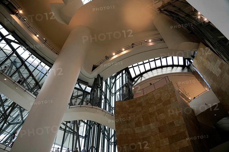 Guggenheim Museum Bilbao, Spain, Europe, The interior features a large atrium with tall pillars and many glass walls, creating a bright and spacious atmosphere, Guggenheim Museum Bilbao on the banks of the Nervion River, architect Frank O. Gehry, Bilbao, Basque Country, Europe