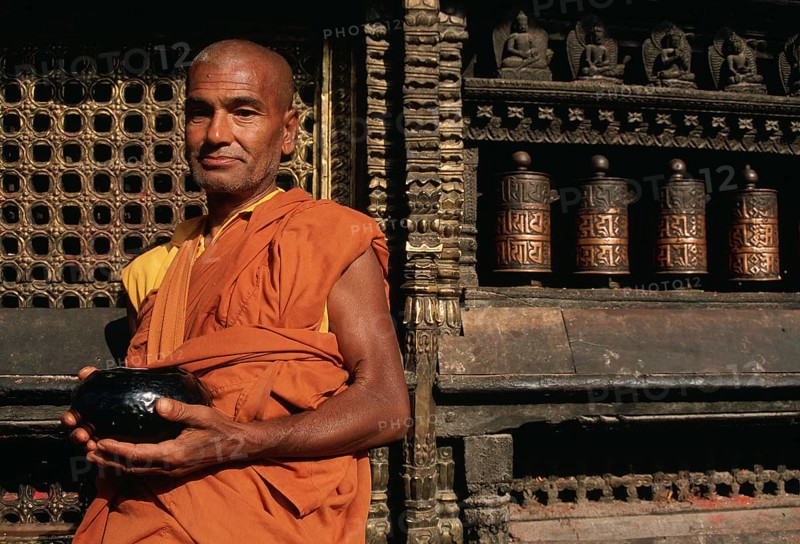 Theravada buddhist monk waiting for alms, nepalese man, Harati temple, Kathmandu valley, Nepal, Asia