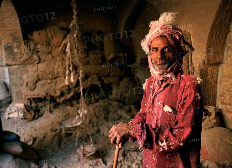 Portrait of a man making woollen mattresses, dirty and dusty work, Bikaner, Rajasthan, India, Asia