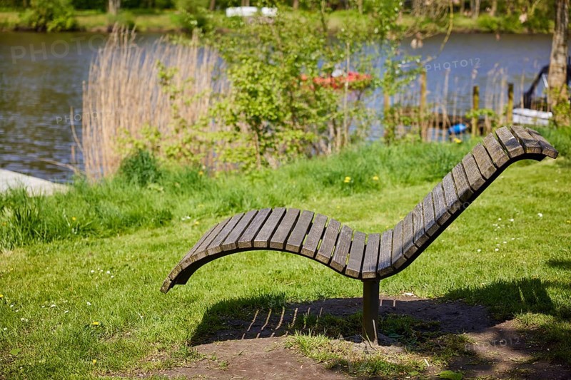 Public wooden deckchair on the banks of the Westersielzug in Friedrichstadt, North Friesland district, Schleswig-Holstein, Germany, Europe