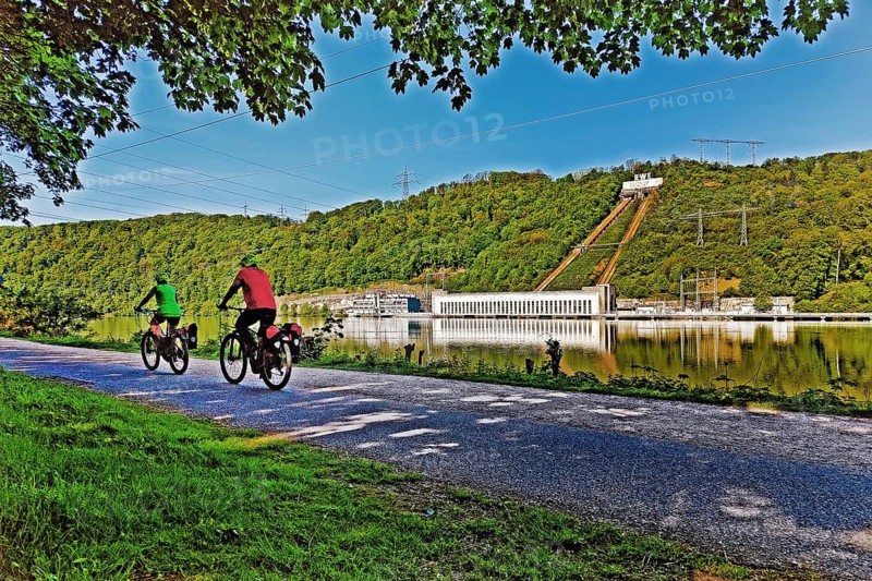 Cyclist at the Hengsteysee in Hagen in front of the Koepchenwerk in Herdecke, North Rhine-Westphalia, Germany, Europe