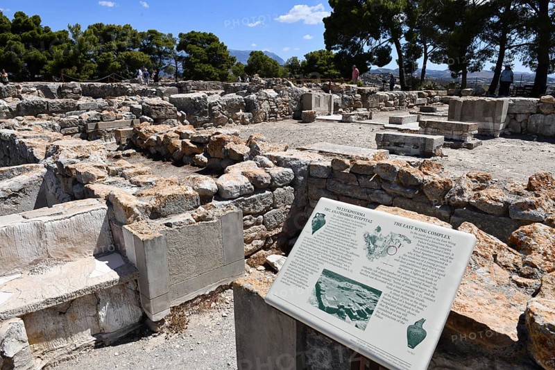 View of east wing complex on hill with foundation walls Ground find of palace of Phaistos settlement from Minoan period Minoan culture, in the foreground tourist information board, Kamilari, Crete, Greece, Europe