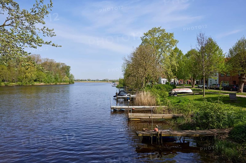 Jetties for pleasure craft on the Westersielzug with the Treene in the background in Friedrichstadt, Nordfriesland district, Schleswig-Holstein, Germany, Europe