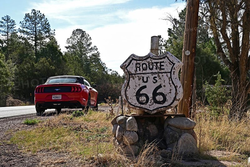 Stone Route 66 road sign with red Ford Mustang convertible behind it, Route 66, Santa Fe, New Mexico