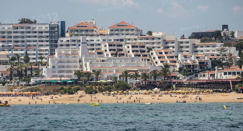 Coast with beach and hotels, people relaxing under parasols Albufeira, Algarve, Portugal, Europe