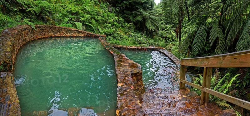 Two turquoise-coloured thermal pools made of stone, surrounded by lush vegetation and ferns, Caldeira Velha thermal springs, Gramas, Caldeiras, Sao Miguel, Azores, Portugal, Europe